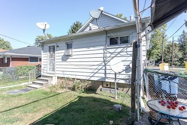 view of side of property with a lawn