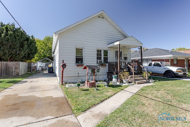 bungalow with a porch and a front yard