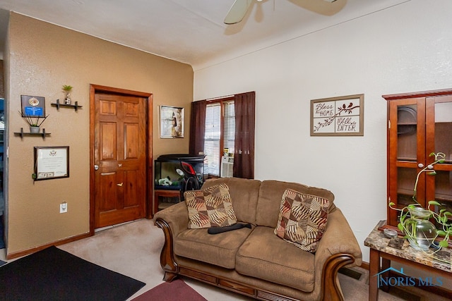 carpeted living room featuring ceiling fan