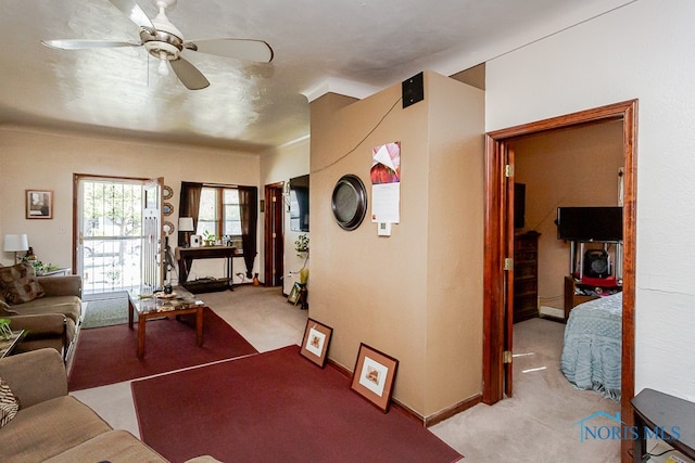 living room featuring ceiling fan and light colored carpet