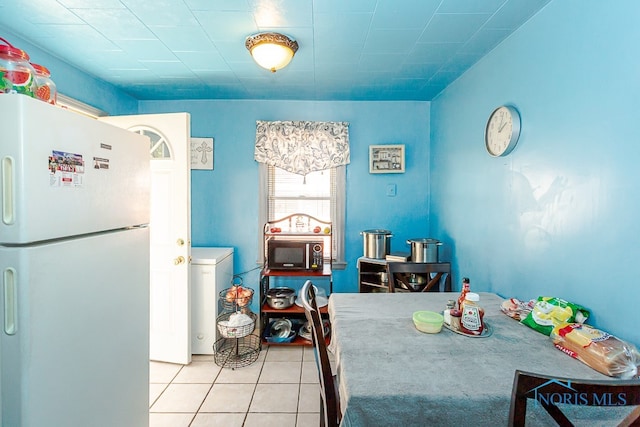 dining area with light tile patterned floors