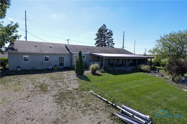 rear view of house with a lawn