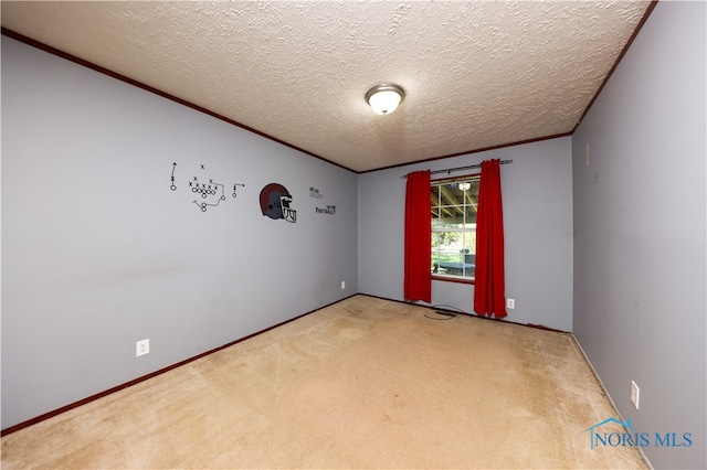 carpeted empty room with a textured ceiling and crown molding