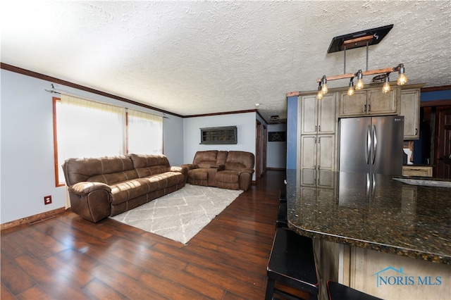 living room featuring dark hardwood / wood-style floors, ornamental molding, and a textured ceiling