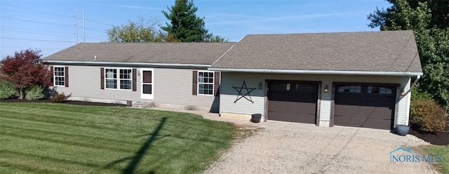 view of front of property featuring a garage and a front lawn