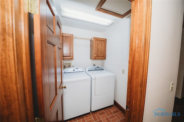 laundry room with cabinets, crown molding, and washing machine and dryer