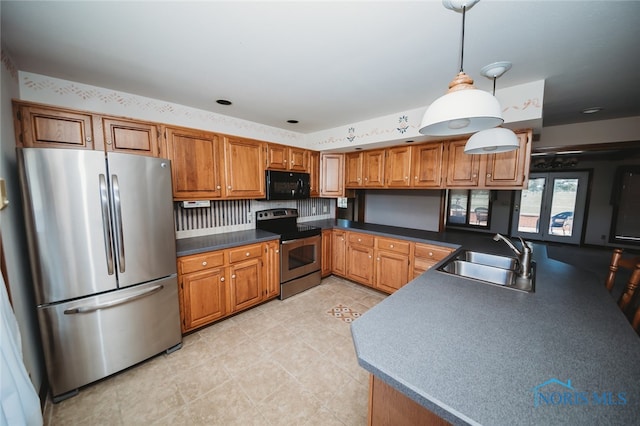 kitchen with light tile patterned floors, sink, decorative light fixtures, stainless steel appliances, and decorative backsplash