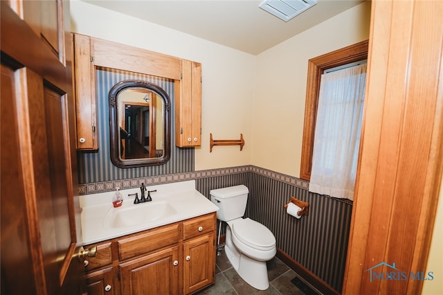 bathroom with vanity, tile patterned flooring, and toilet