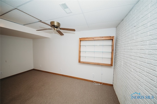 carpeted spare room with ceiling fan and a paneled ceiling