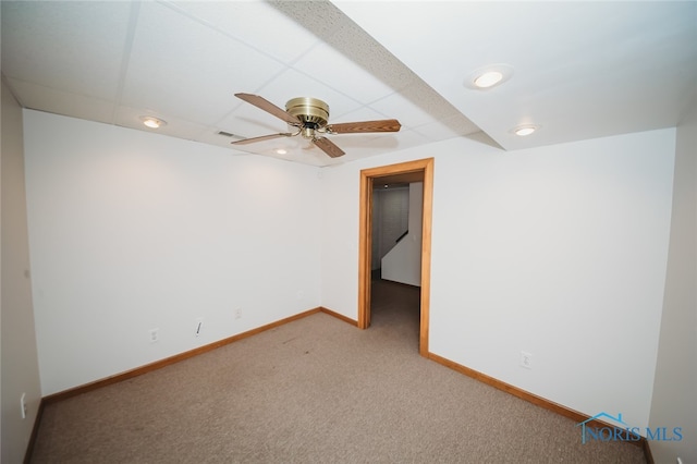 carpeted spare room featuring ceiling fan