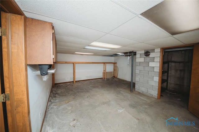 basement with a paneled ceiling