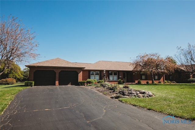 ranch-style house with a garage and a front lawn