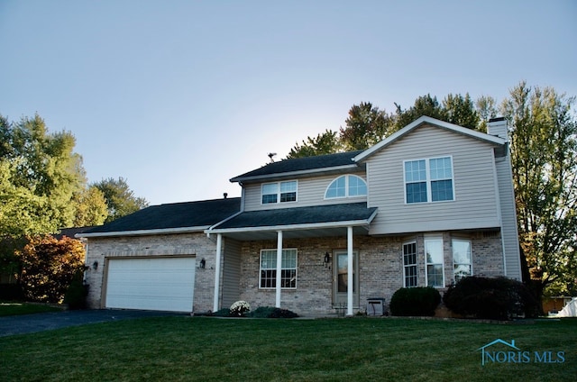 view of property with a garage and a front yard