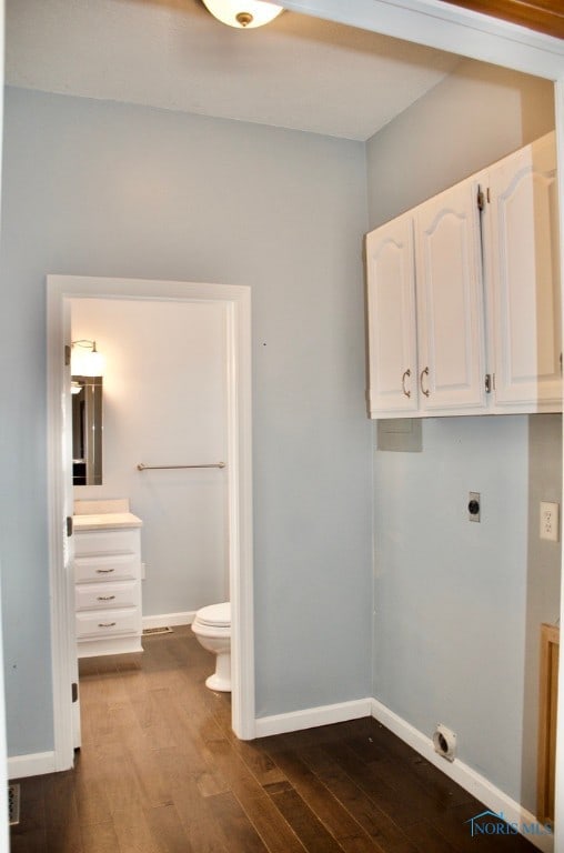 laundry area featuring cabinets, hardwood / wood-style flooring, and hookup for an electric dryer