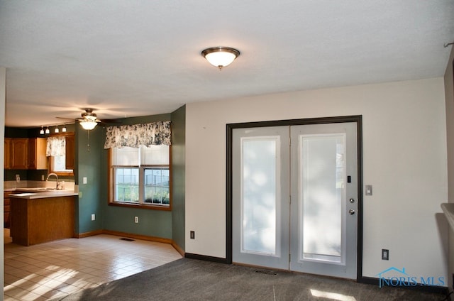 interior space with ceiling fan, light tile patterned floors, and a textured ceiling