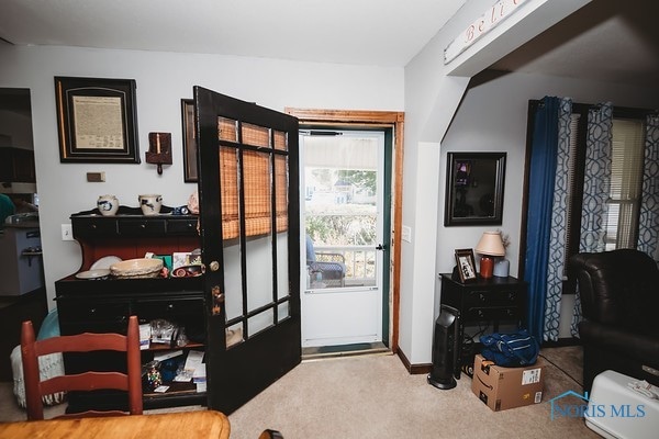 doorway to outside featuring carpet flooring