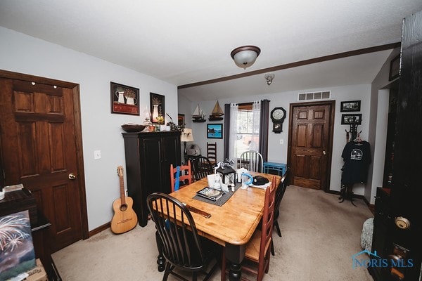 dining room with light colored carpet