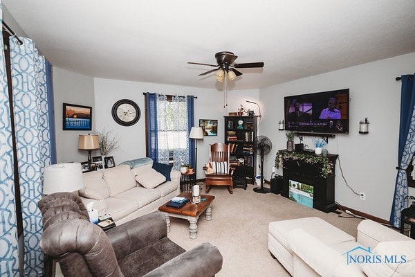 living room featuring ceiling fan and carpet flooring