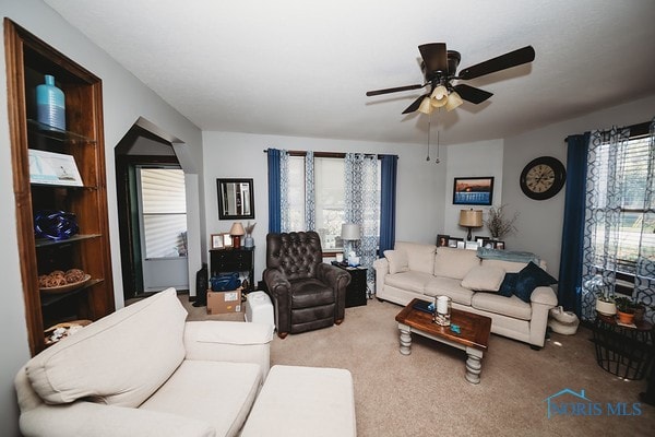 carpeted living room featuring ceiling fan