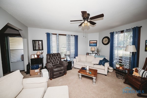 carpeted living room featuring ceiling fan