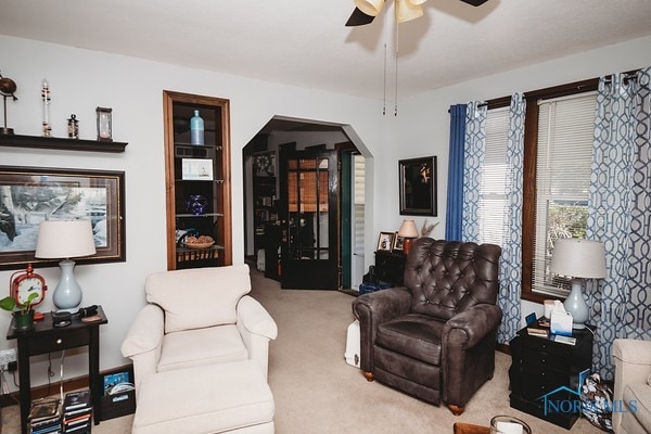 living room featuring light carpet and ceiling fan