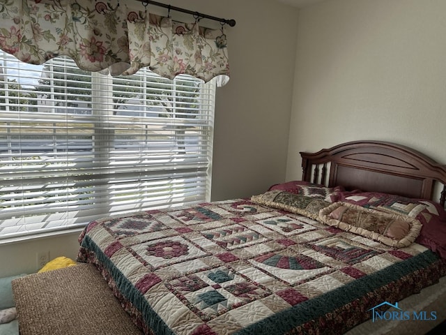 bedroom featuring multiple windows