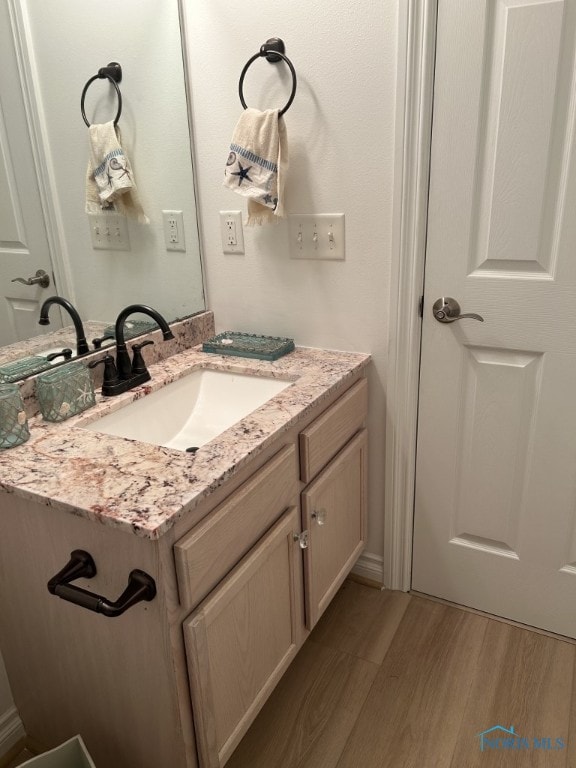 bathroom featuring vanity and hardwood / wood-style floors