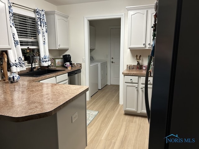 kitchen featuring sink, light hardwood / wood-style flooring, white cabinetry, dishwasher, and separate washer and dryer