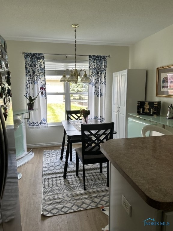 dining room featuring a chandelier and light hardwood / wood-style floors