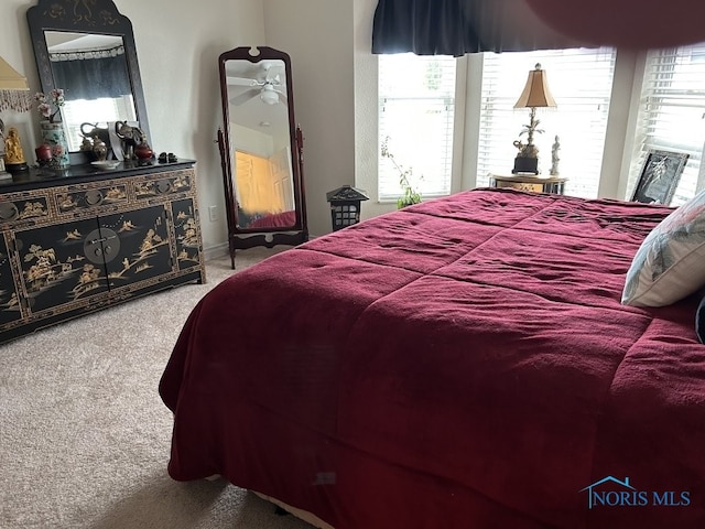 bedroom with carpet flooring and multiple windows