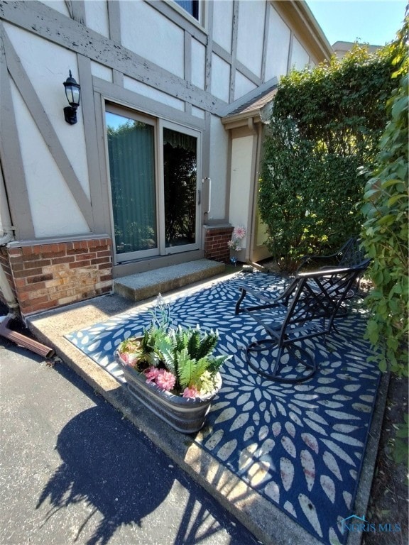 entrance to property with a patio