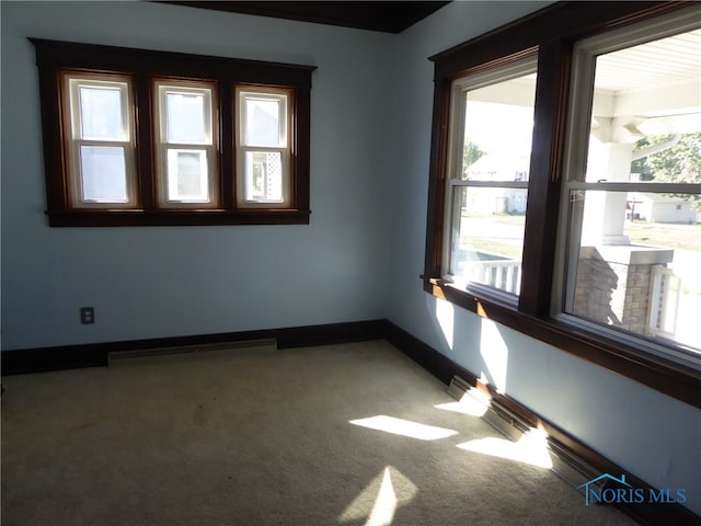 carpeted spare room featuring a wealth of natural light