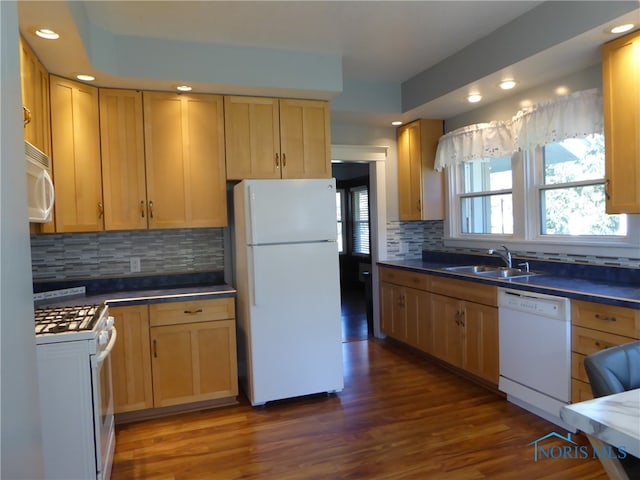 kitchen with dark wood-type flooring, sink, tasteful backsplash, light brown cabinetry, and white appliances