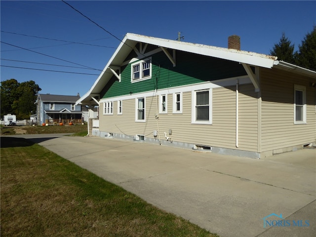 view of side of property with a yard