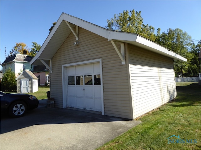 garage featuring a lawn