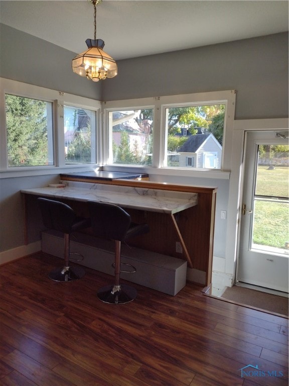 interior space featuring dark hardwood / wood-style flooring and a chandelier