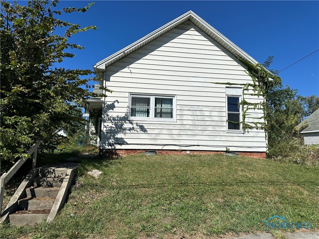 view of side of property with a yard