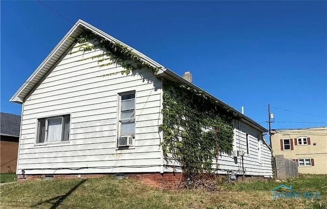 view of home's exterior with cooling unit and a yard