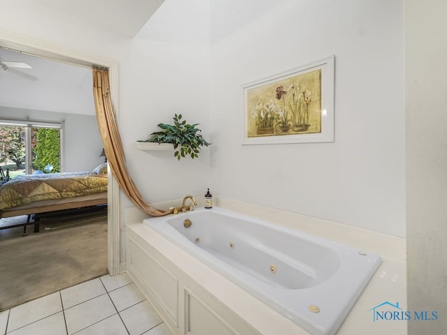 bathroom featuring ceiling fan, a bath, and tile patterned flooring