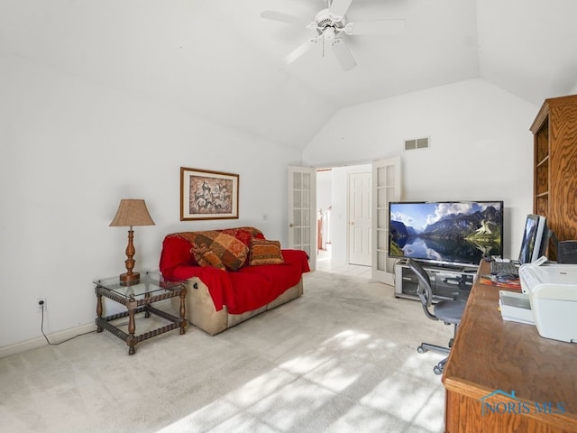 office space with ceiling fan, vaulted ceiling, and light colored carpet