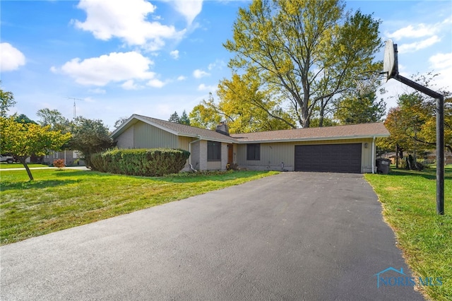 single story home with a front lawn and a garage