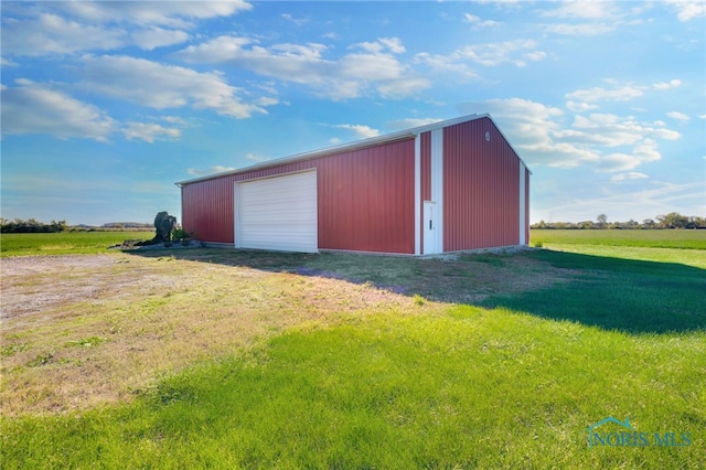 view of outbuilding with a yard and a garage