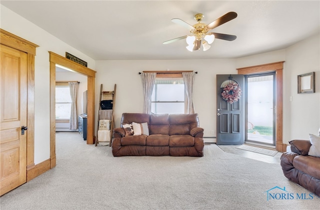 living room featuring a baseboard radiator, light colored carpet, and ceiling fan