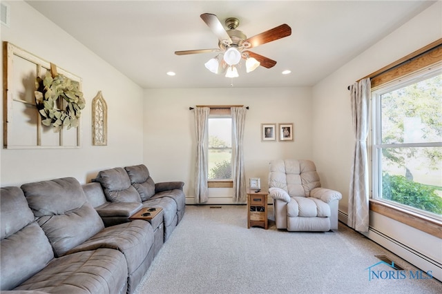 living room with a baseboard radiator, light carpet, and ceiling fan