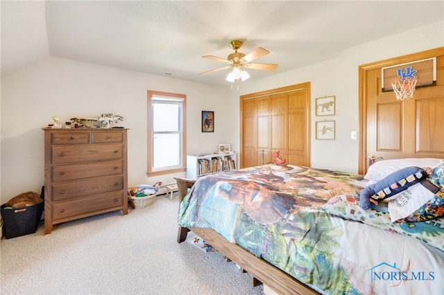 bedroom featuring lofted ceiling, carpet floors, a closet, and ceiling fan