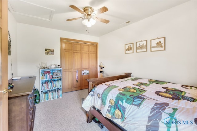 carpeted bedroom featuring a closet and ceiling fan