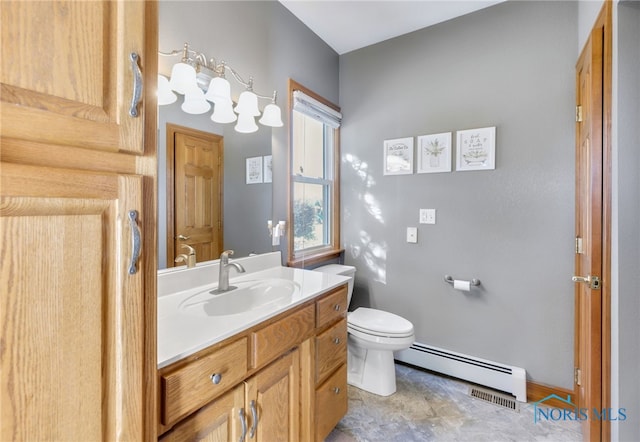 bathroom with vanity, toilet, and baseboard heating