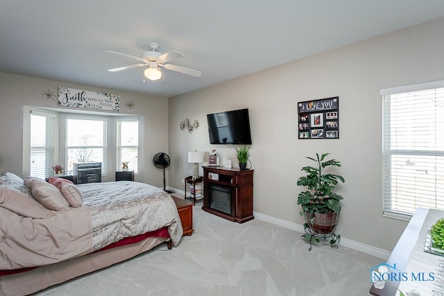 bedroom with light carpet and ceiling fan