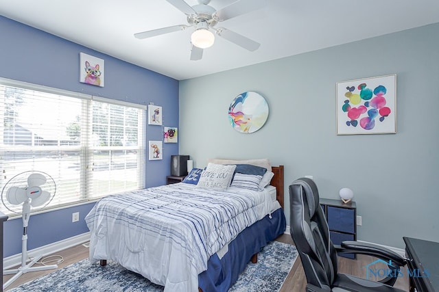 bedroom with hardwood / wood-style flooring and ceiling fan