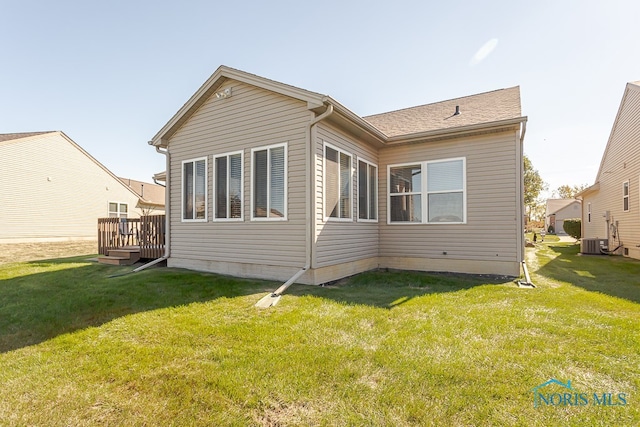 back of property featuring a yard, a wooden deck, and central air condition unit